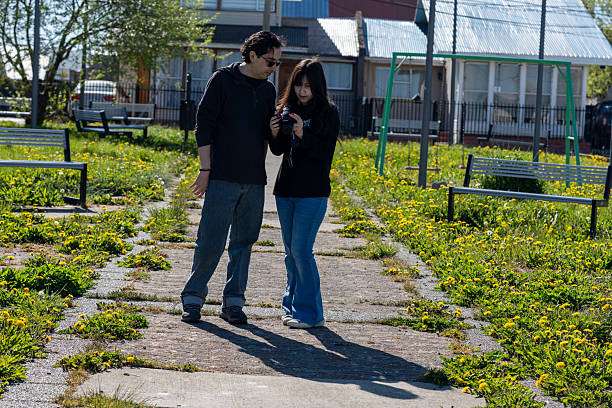 Father and Daughter Looking at Digital Camera