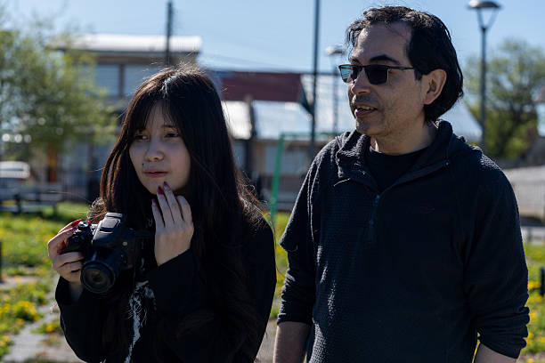 istock Man and Young Woman Observing Surroundings While Holding a DSLR 2249404042