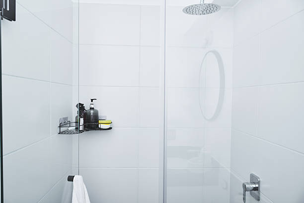 istock Modern bathroom shower with hygiene products and white tiles 2249404597
