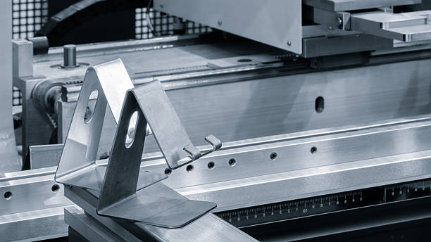 istock metal pieces are being cut by machine. pieces all same size and shape, they are arranged in a row. machine is cutting through metal with precision. 2249404689