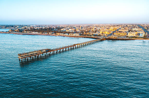 drone view on Swakopmund Pier and coast line at sunset hour
