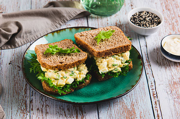 istock Eggs, avocado on lettuce leaves on toast on a plate on the table 2249406940