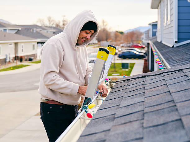 istock Man Installing Christmas Lights on a Home 2249408857