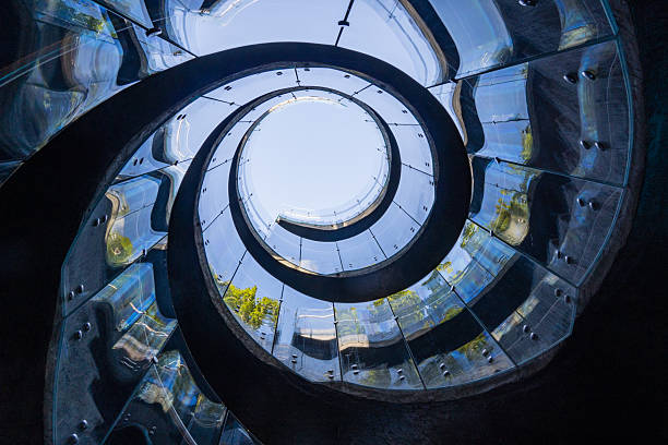 istock Mesmerizing view from below through reflective glass and steel. Spectacular spiral staircase leads to Rabbit Hole location in Cloud Park.  Krasnodar City Park or Galitsky Park in Krasnodar. 2249410676