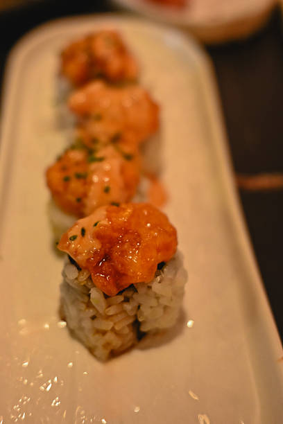 Spicy baked salmon maki roll sushi on plate