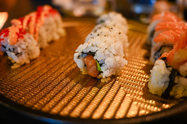 istock Fresh sushi rolls serving on golden plate at restaurant 2249412233