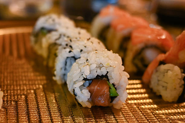 Fresh sushi rolls serving on golden plate at restaurant
