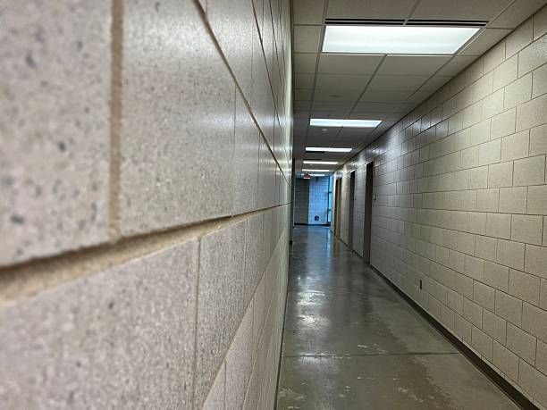 istock Long hallway with white stone block walls 2249416041