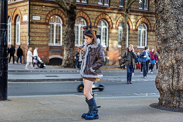 Shaftesbury Avenue, London, England, United Kingdom, Europe - November 1st 2025: Young woman in a quiet moment in the heart of London’s famous theatre district