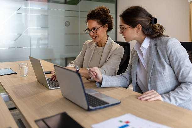 istock Two Businesswomen Collaborating in Modern Office Meeting 2249416526