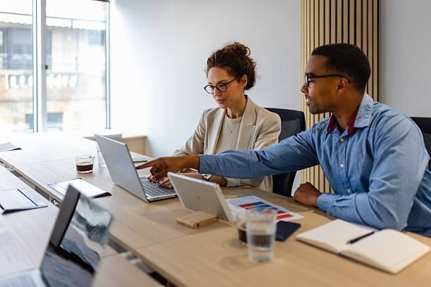 istock Female Executive and Black Male Colleague Discussing Project Data 2249416587