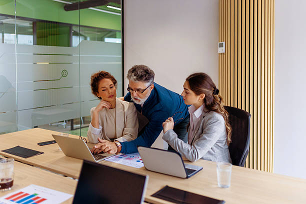 istock Senior Executive Mentoring Two Female Colleagues in Office 2249416742