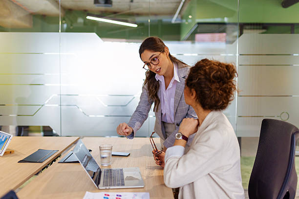 istock Female Team Members Brainstorming with Laptops 2249416746