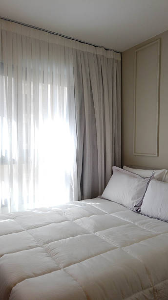 istock Serene Cozy Bedroom with Fabric Curtains and Warm Natural Light 2249418231
