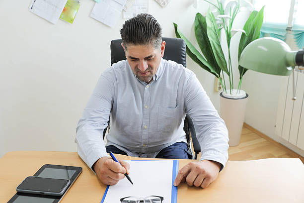 Businessman, employee sitting at table and working. Journalism, social media marketing. Contemporary art collage. Concept of business, employment, retro style, surrealism. Paper, noise effect
