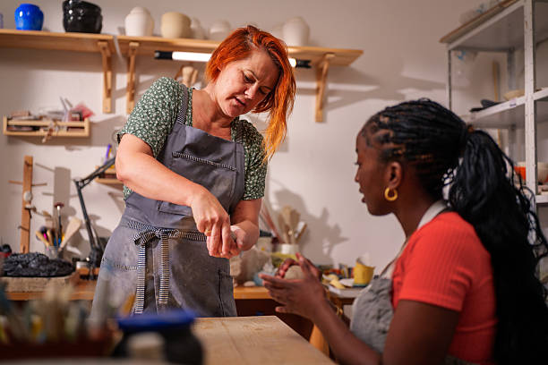 istock In a pottery workshop, a skilled artisan shares her passion for ceramics while teaching her apprentice the intricate process of preparing clay, fostering creativity and connection 2249421249