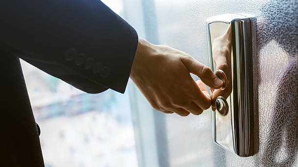 istock Close-up. A human finger presses an elevator button. A man's hand indoors. A red button. Concept of technology. 2249421521