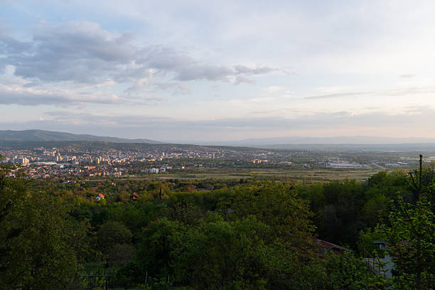 istock Panoramic view of the city with dramatic sky above and forest in front 2249426793