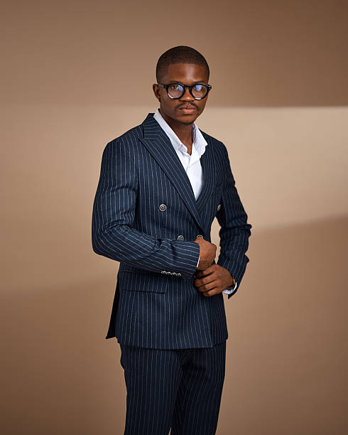 istock Man in pinstripe suit wearing glasses posing in studio 2249428801
