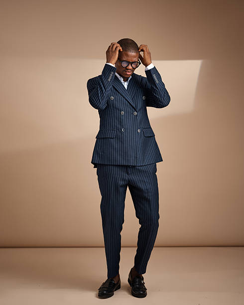istock Man touching head while wearing pinstripe suit in studio 2249428805