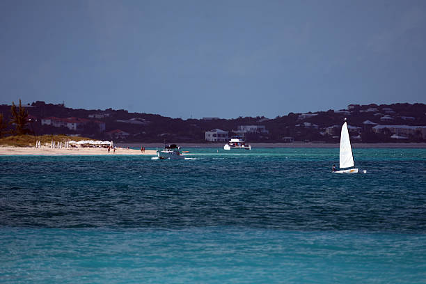 view of rocky rugged shore with white sand beach and turquoise lagoon at anguilla island