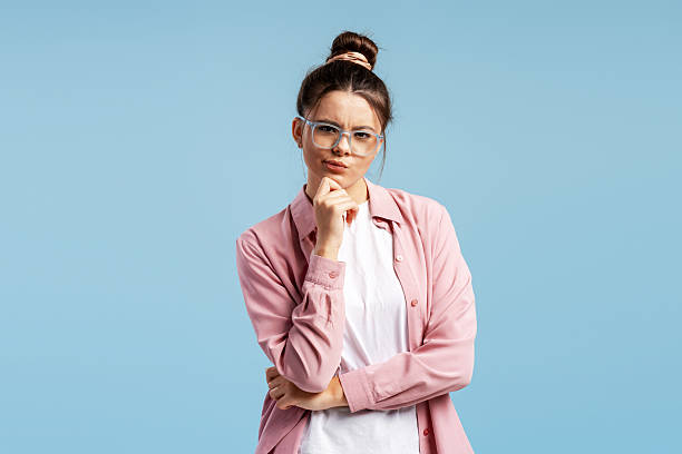 istock Young adult woman pondering, thinking with doubt and making a decision 2249438033