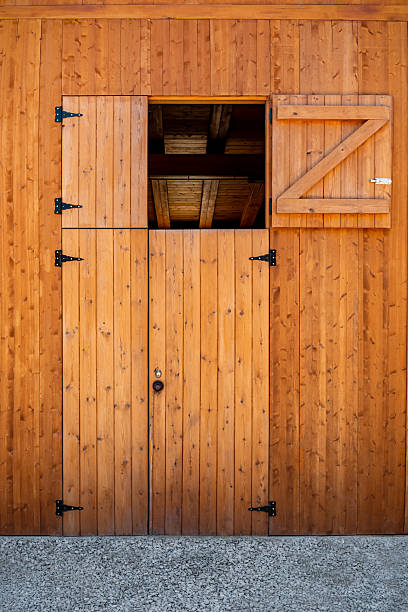 istock Dutch barn door with open top half and Z-braced wooden panel 2249441607