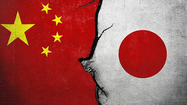 istock Two cracked walls with China and Japan national flags facing each other. Conflict between China against Japan 2249443698