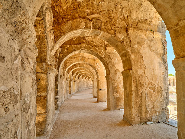 A breathtaking view through the arched corridors of the Aspendos Ruins and Theatre in southern Turkey, near Antalya. This historic site exhibits remarkable classical architecture preserved from antiquity.
