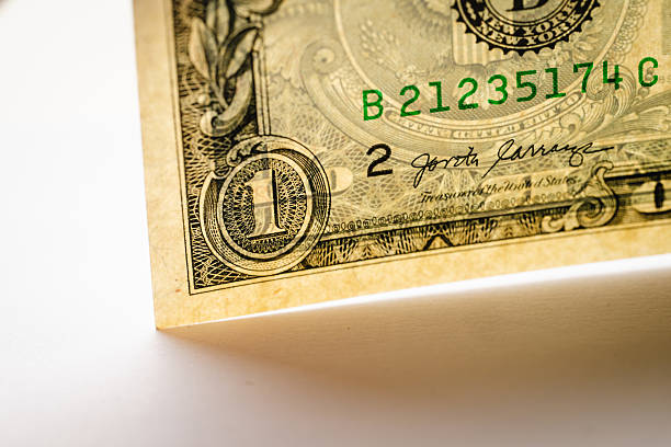 One dollar bill rolled up isolated on white background.