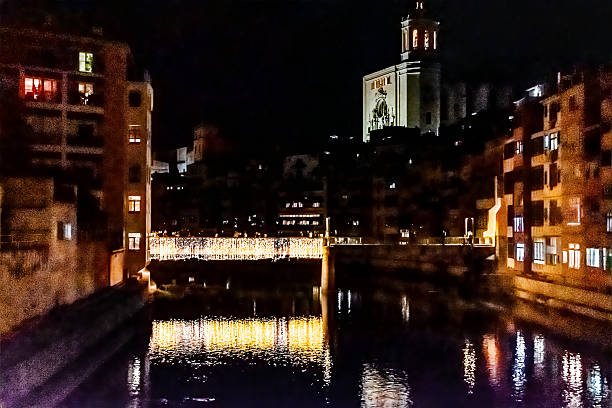 istock Illuminated pedestrian Saint Agusti bridge decorated with Christmas lights reflecting in Onyar river at night, Spain 2249448363