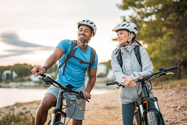 istock Active Couple with Electric Bikes at Seafront Sunrise 2249449177