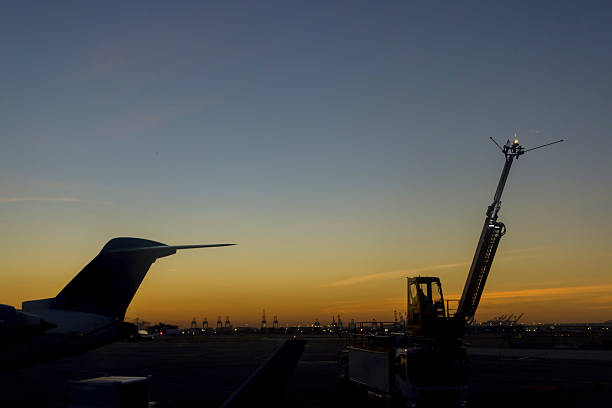 istock Sunset view at an airport with service equipment planes in foreground 2249452002