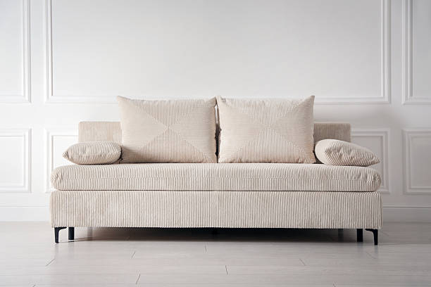 istock Comfortable sofa with pillows near white wall indoors 2249453302