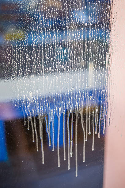 istock Window cleaning brush. Large window in a multi-storey building, cleaning service. Window cleaning in high-rise buildings, houses with a brush. Dust removal and glass washing. 2249454321