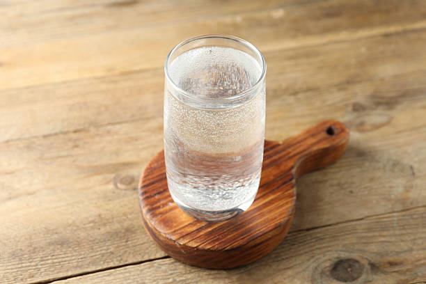 istock Refreshing soda water in glass on wooden table, closeup 2249455281