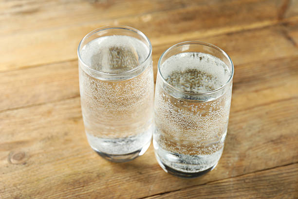 istock Refreshing soda water in glasses on wooden table, closeup 2249455320