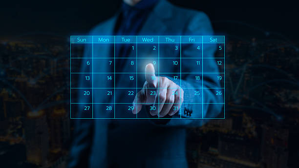istock A business professional interacts with a glowing digital calendar interface, symbolizing scheduling, time management, planning, and futuristic productivity tools for modern corporate workflows. 2249456994