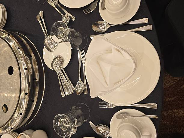 istock An elegant overhead view of a formal dinner or banquet table setting with a dark tablecloth. 2249457761