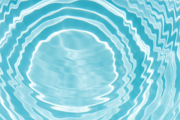 istock Blue water with ripples on the surface. Defocus blurred transparent blue colored clear calm water surface texture with splashes and bubbles. Water waves with shining pattern texture background. 2249469461