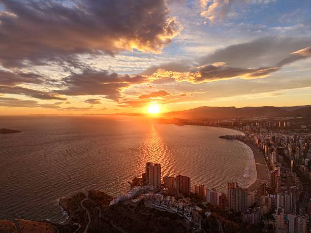 istock sunset casts striking shadows over serene bay with reflective orange light and urban outlines 2249473300