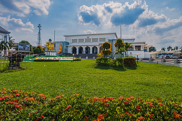 Tenggarong, Indonesia - October 11 2025. The historic Museum Mulawarman building in Tenggarong, East Kalimantan, showing the white Dutch Colonial architecture, green lawn, and the golden Lembuswana statue, a work by an artist from Burma (now Myanmar). This statue was created around 1850, commissioned specifically by the Sultan of Kutai Kartanegara as a symbol or icon of the kingdom.