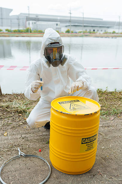 istock Ecologists in protective gear work to check the water conditions in a pond on a farm where aquatic animals are kept and collect water samples for analysis. 2249480497