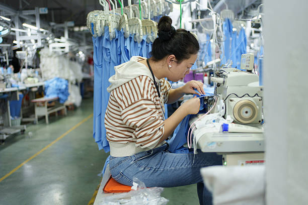 istock Busy female workers in a garment factory 2249483516