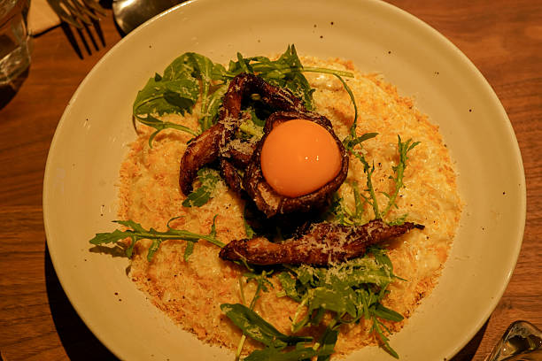 istock Creamy Risotto Topped with Grilled Chicken and Egg Yolk 2249485141