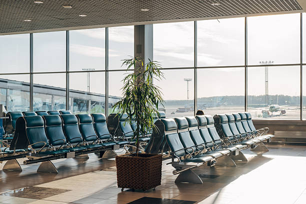 istock Waiting area with blue seats in new airport terminal. 2249486854