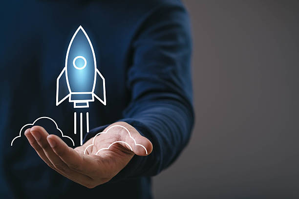 istock Hand presenting a glowing rocket startup icon, symbolizing business growth, innovation, new beginnings, technology launch, creative ideas, future development, and successful project acceleration. 2249492367