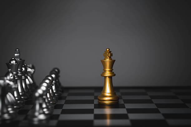 istock Golden king chess piece standing alone against silver opponents, symbolizing leadership, strategy, competition, power, decision-making, business dominance, strategic advantage challenging situations 2249492369