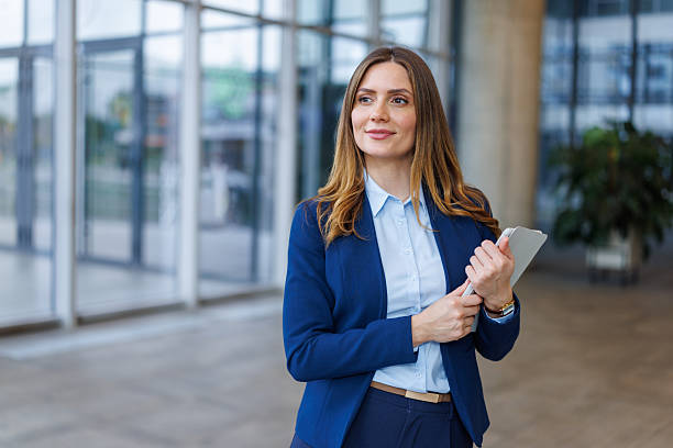 istock Confident businesswoman holding tablet looking forward in modern office 2249492989