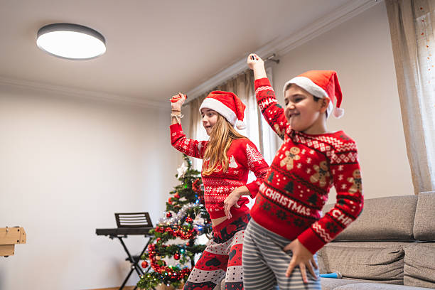 istock Siblings wearing santa hats playing video game on christmas day 2249493863
